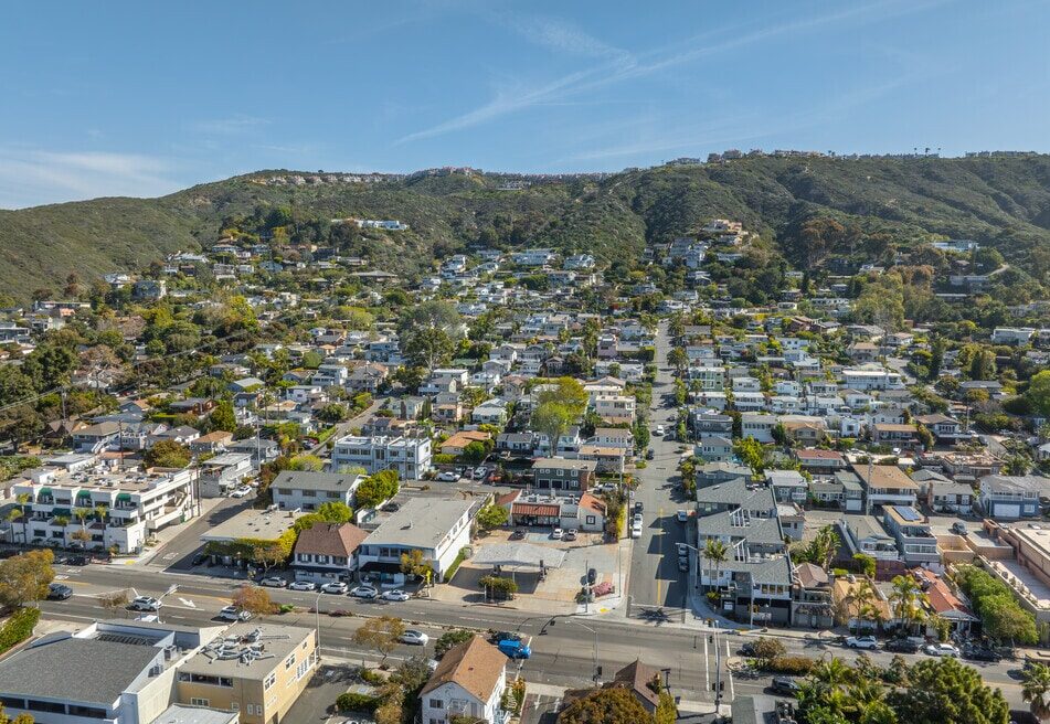An aerial view of the South Laguna Beach village and residential hillside – Monitoring the intersection of community planning, home values, and coastal preservation.