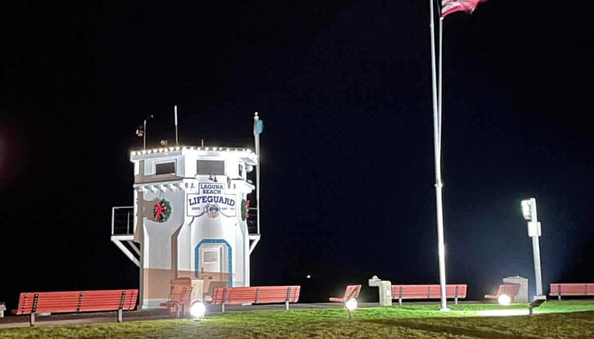 The illuminated Main Beach Lifeguard Tower at night – A symbol of the constant vigilance and community support of the So Laguna Neighborhood Association.