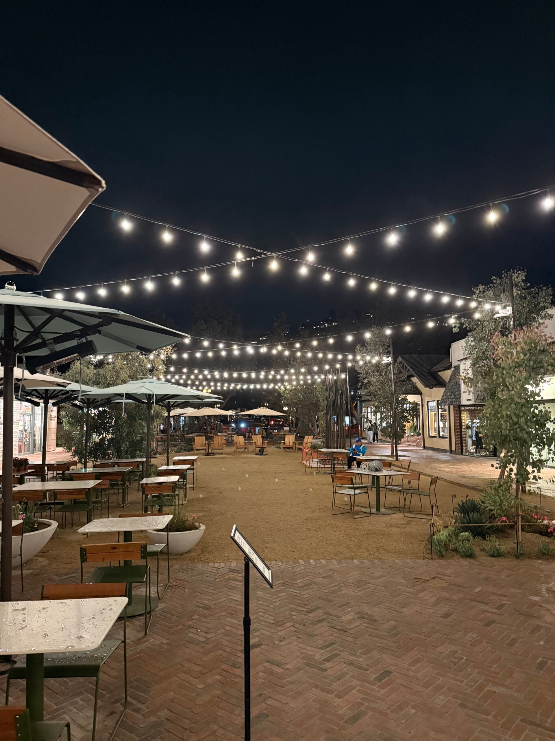 Completed Promenade on Forest in Laguna Beach illuminated by string lights at night