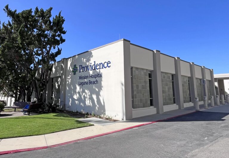 Exterior view of the Providence Mission Hospital Laguna Beach building entrance, highlighting the facility that is currently facing a phase-out of its Emergency Room and acute care services.