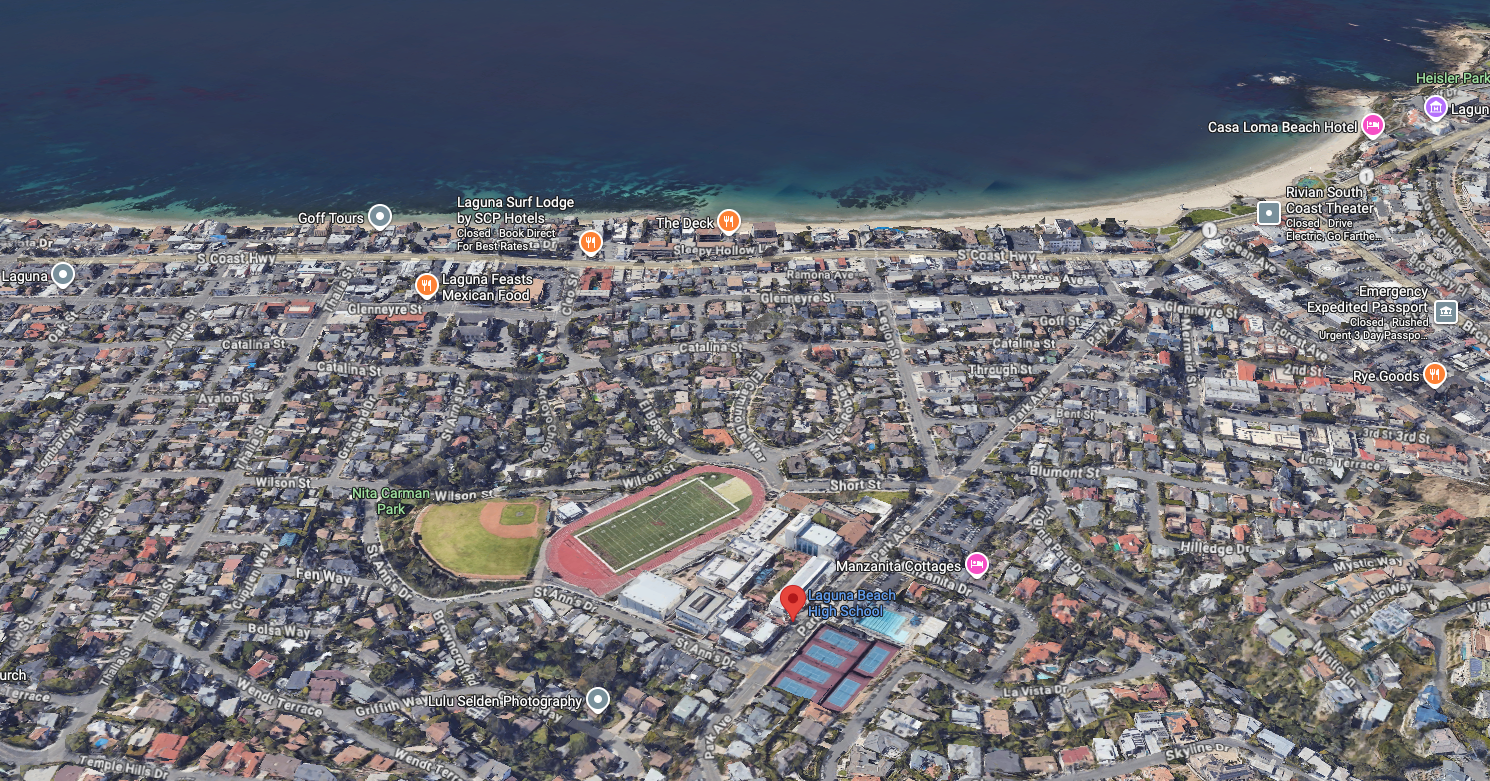 Aerial perspective of Laguna Beach, California, highlighting the coastal community and prominent features such as the Laguna Beach High School campus, football field, baseball diamond, and surrounding neighborhood, contextualizing the recent LBUSD Board of Education vote regarding Superintendent Dr. Jason Glass for the So Laguna Neighborhood Association.
