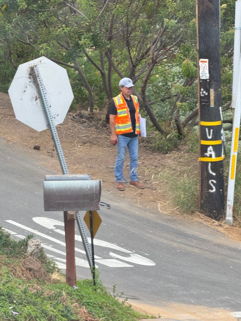 City utility worker inspecting a wooden power pole on Virginia Way in Laguna Beach.